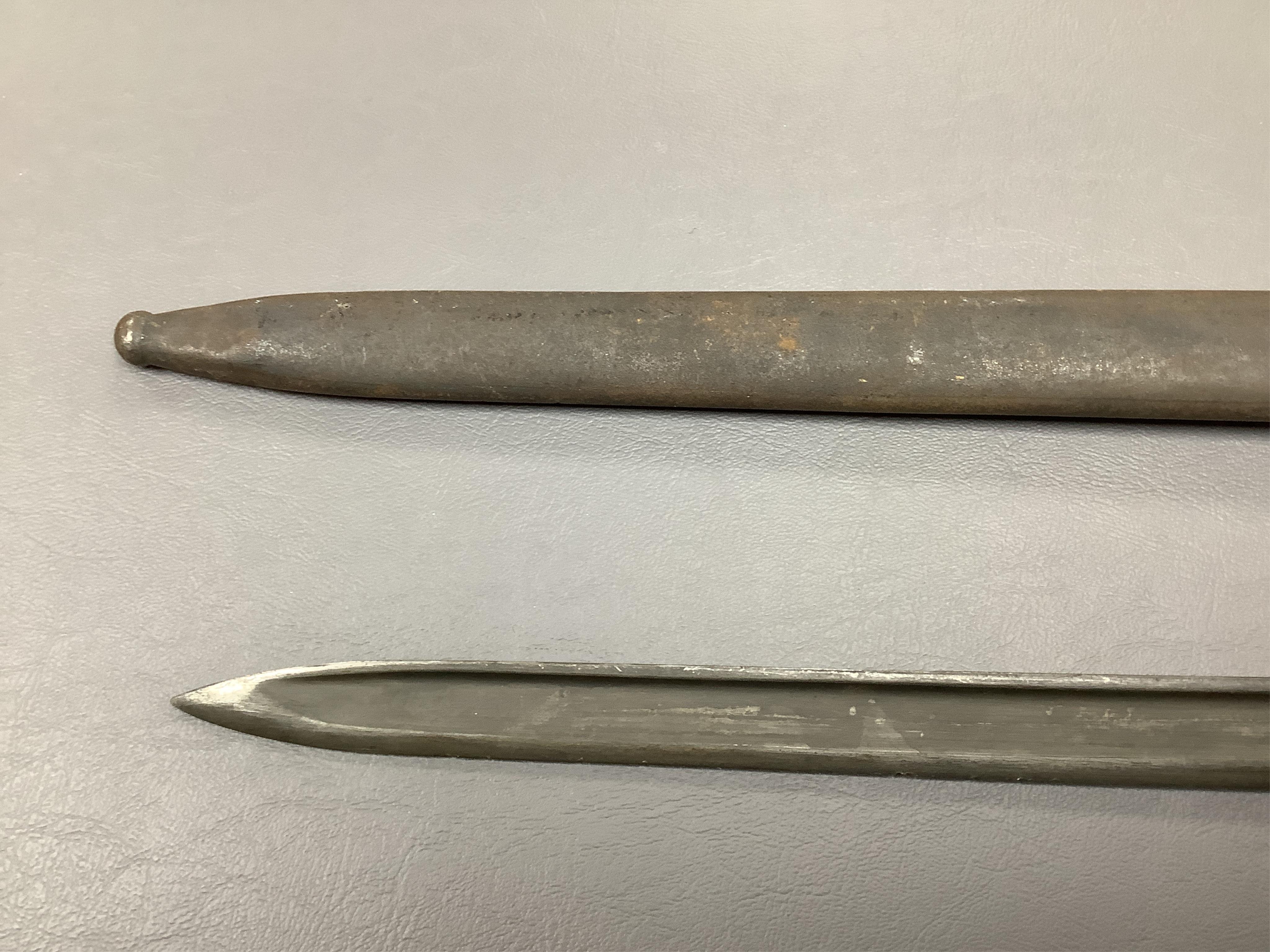 A First World War Turkish army officer’s sword, with pipe back blade, regulation iron guard pierced with crescent and moon, chequered horn grips, in its iron scabbard, together with an unidentified bayonet in its scabbar